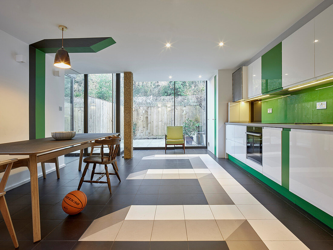 Modern kitchen-dining room with green accents and graphic details
