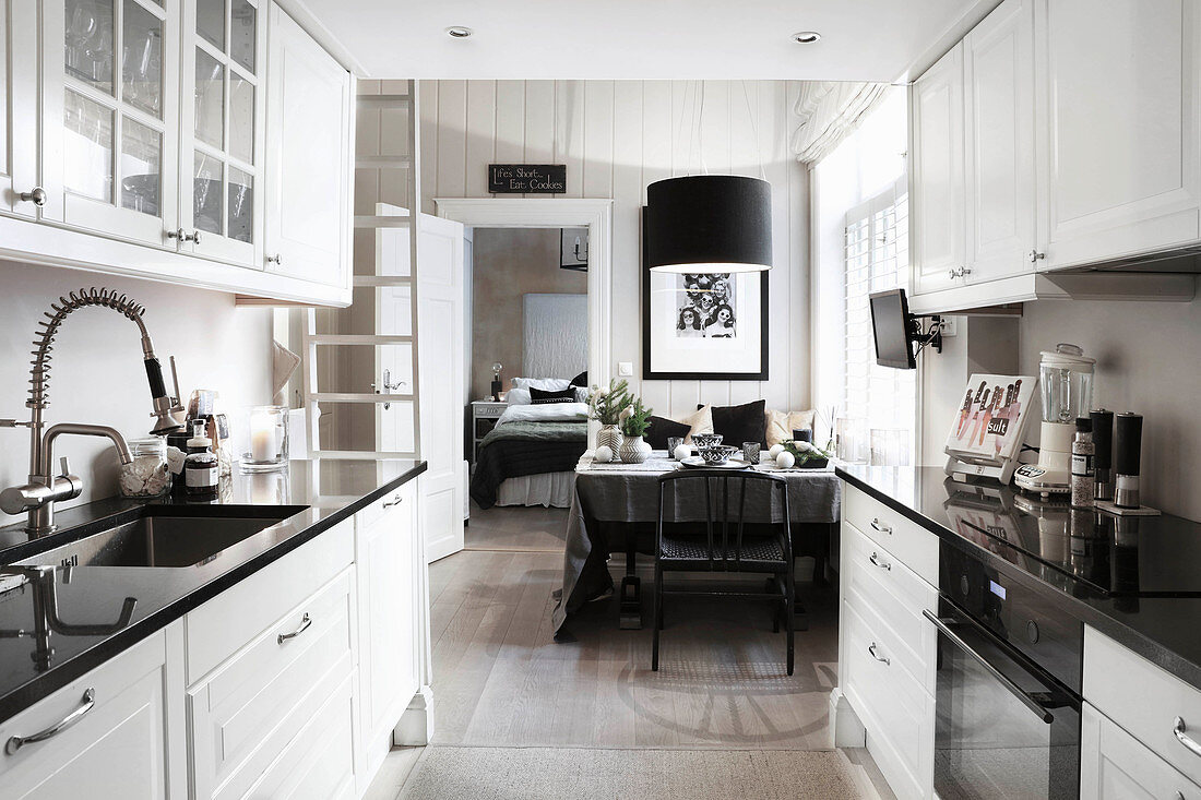 View from open-plan kitchen into dining room and bedroom