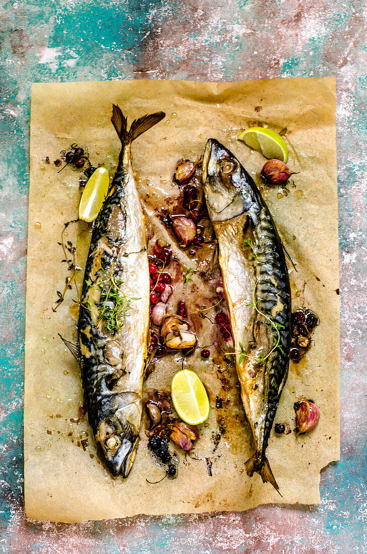 Baked Mackerel Fish with Herbs and Lemon on a colorful surface