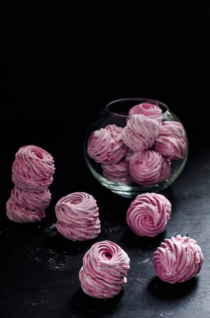 Pink zefir on a black surface