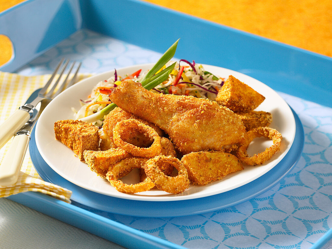 Breaded chicken legs and vegetable sides