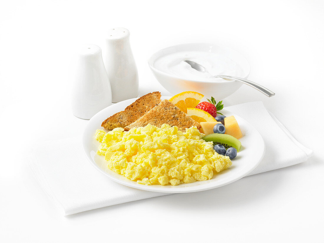Scrambled eggs with fruit, toast and yoghurt