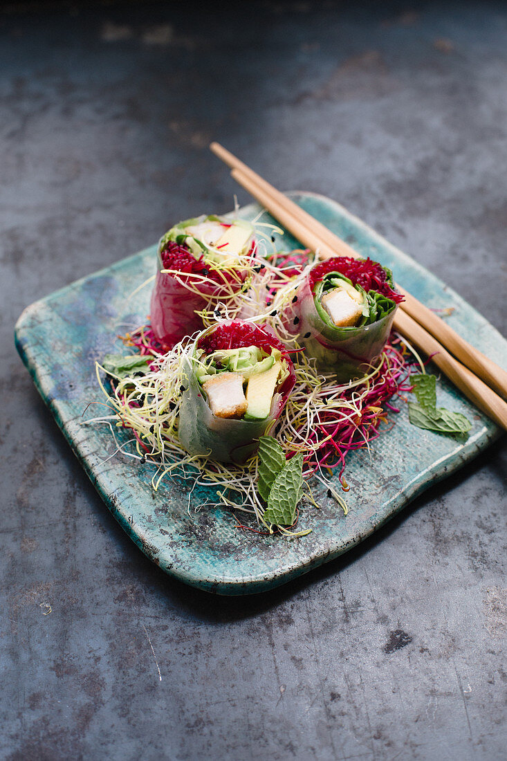 Rice paper rolls filled with chicken escalope, beetroot rice noodles, lettuce, avocado, coriander and mint