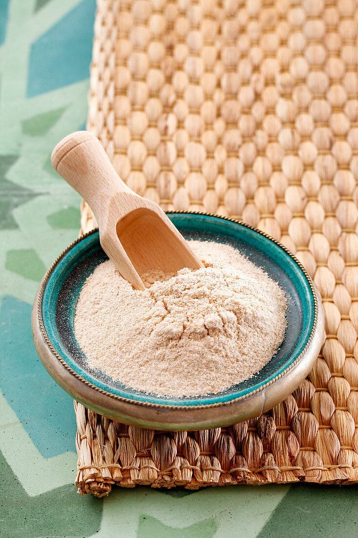 A bowl of tsampa flour with a wooden scoop (Tibet)