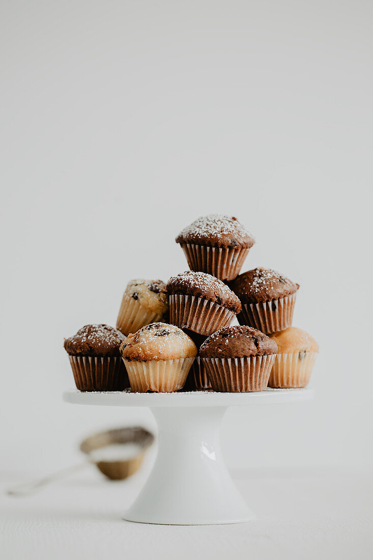 Mini muffins with chocolate drops on a cake stand