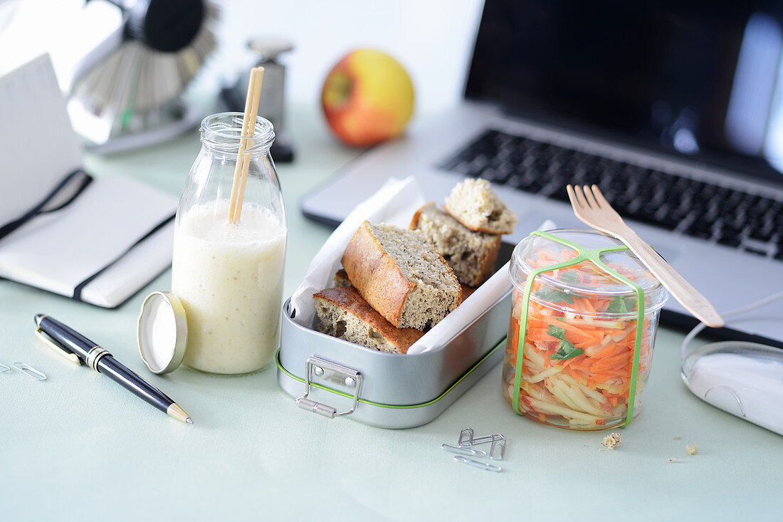 A mango and banana smoothie, banana bread and an apple and carrot salad