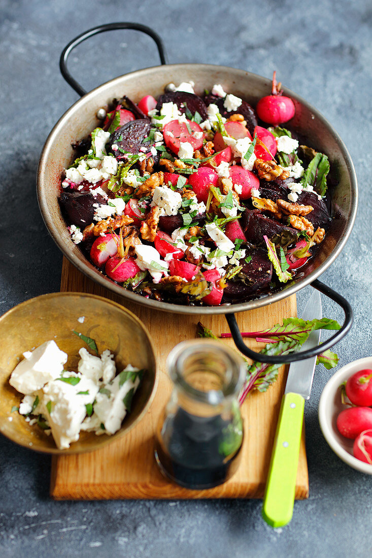 Oven-baked beetroot with radishes, feta cheese and walnuts