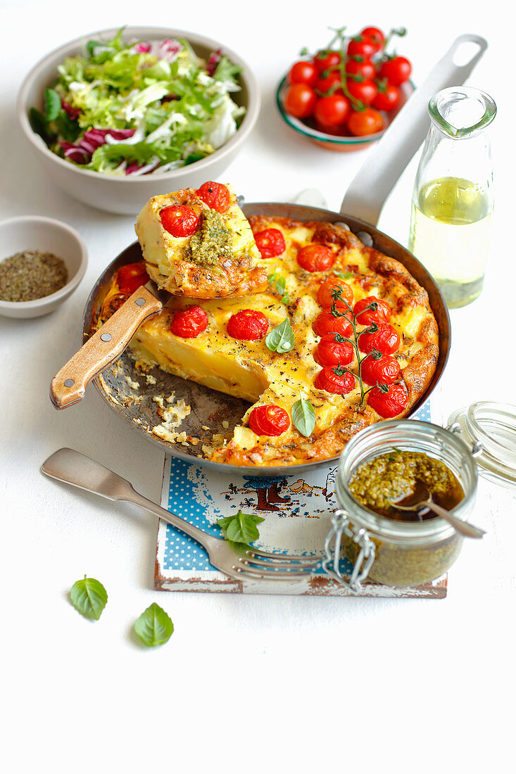 Potato tortilla with cherry tomatoes and pesto