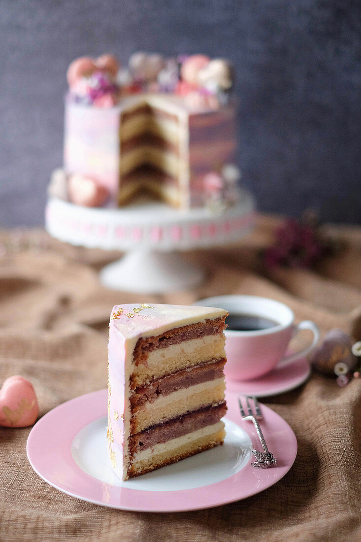 A berry cake with white chocolate and macaroons, sliced