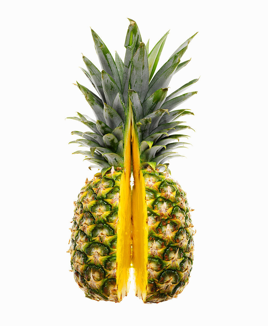 Fresh Pineapple Sliced in Half Against White Background
