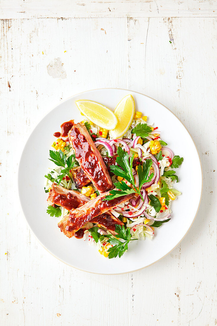 Lammrippen auf Weisskohl-Mais-Salat mit roten Zwiebeln und Petersilie