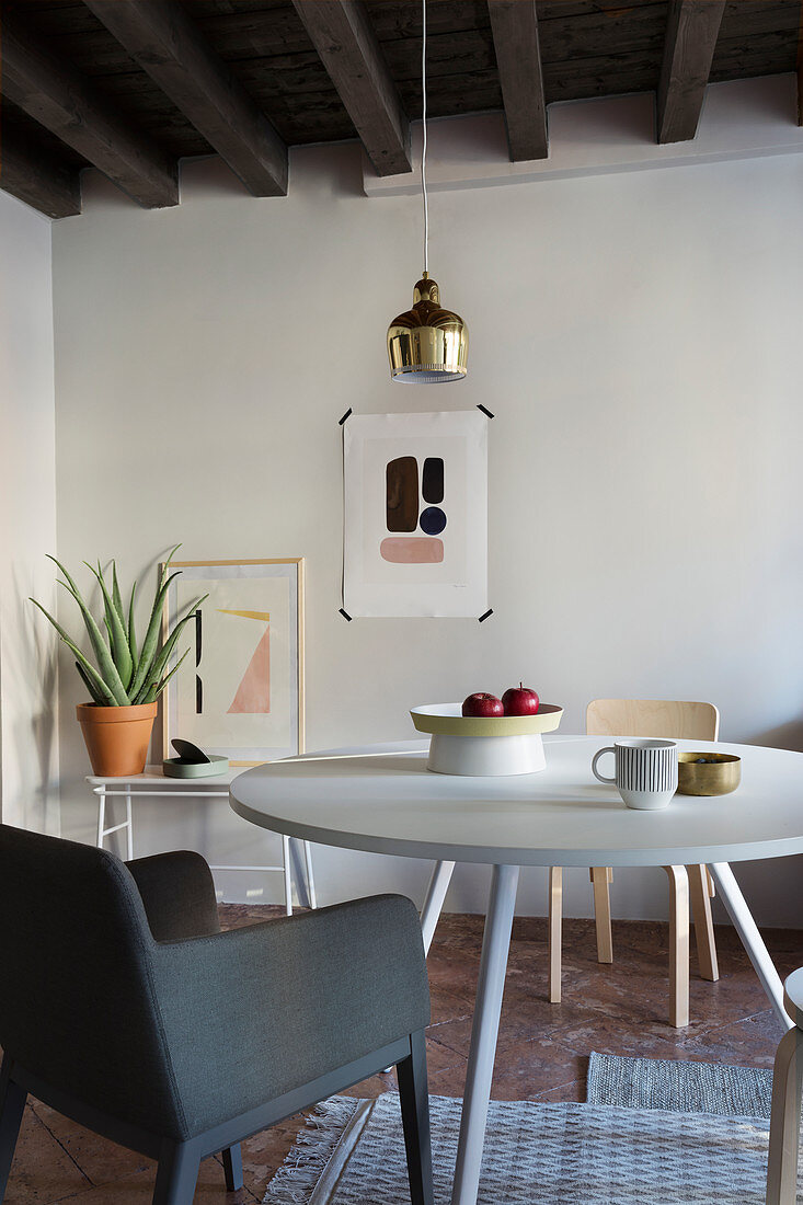 Scandinavian-style round dining table and accessories