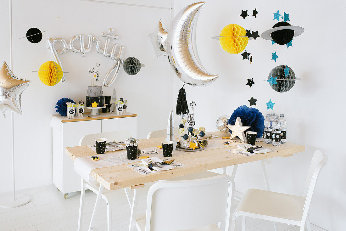 Space party: table festively set for child's birthday party