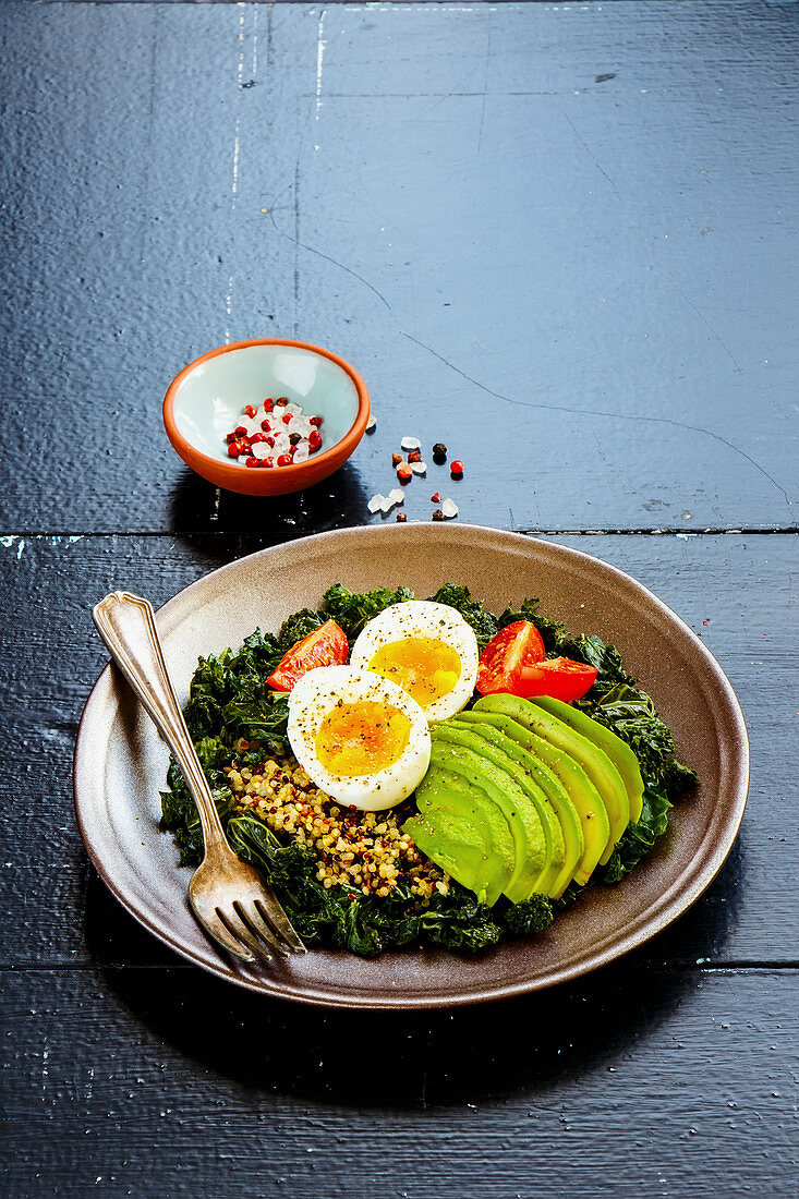 Qunioa salad with kale, avocado, egg and tomatoes