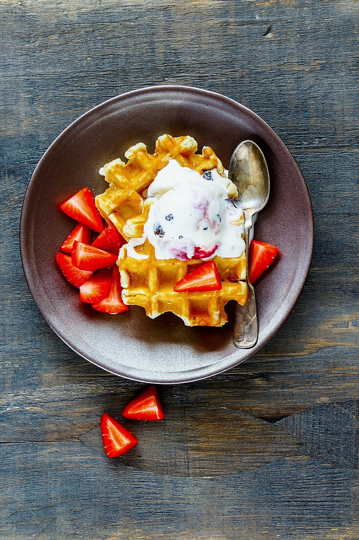 Belgian waffles with strawberries and ice cream (seen from above)