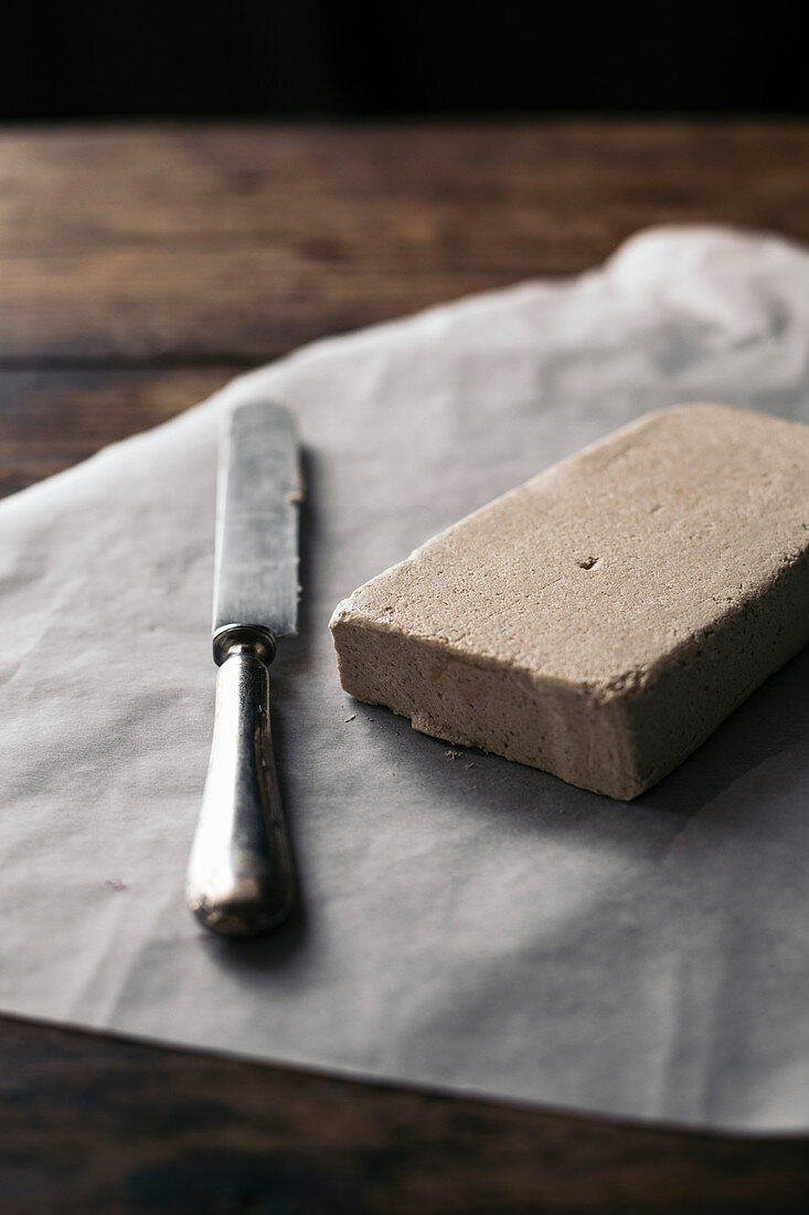 Halva on a piece of paper with a knife