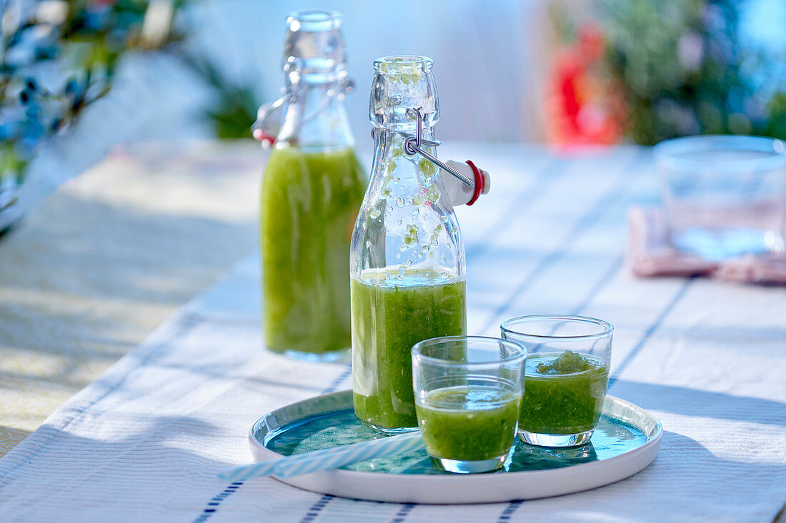 Cucumber gazpacho in a bottle and glasses
