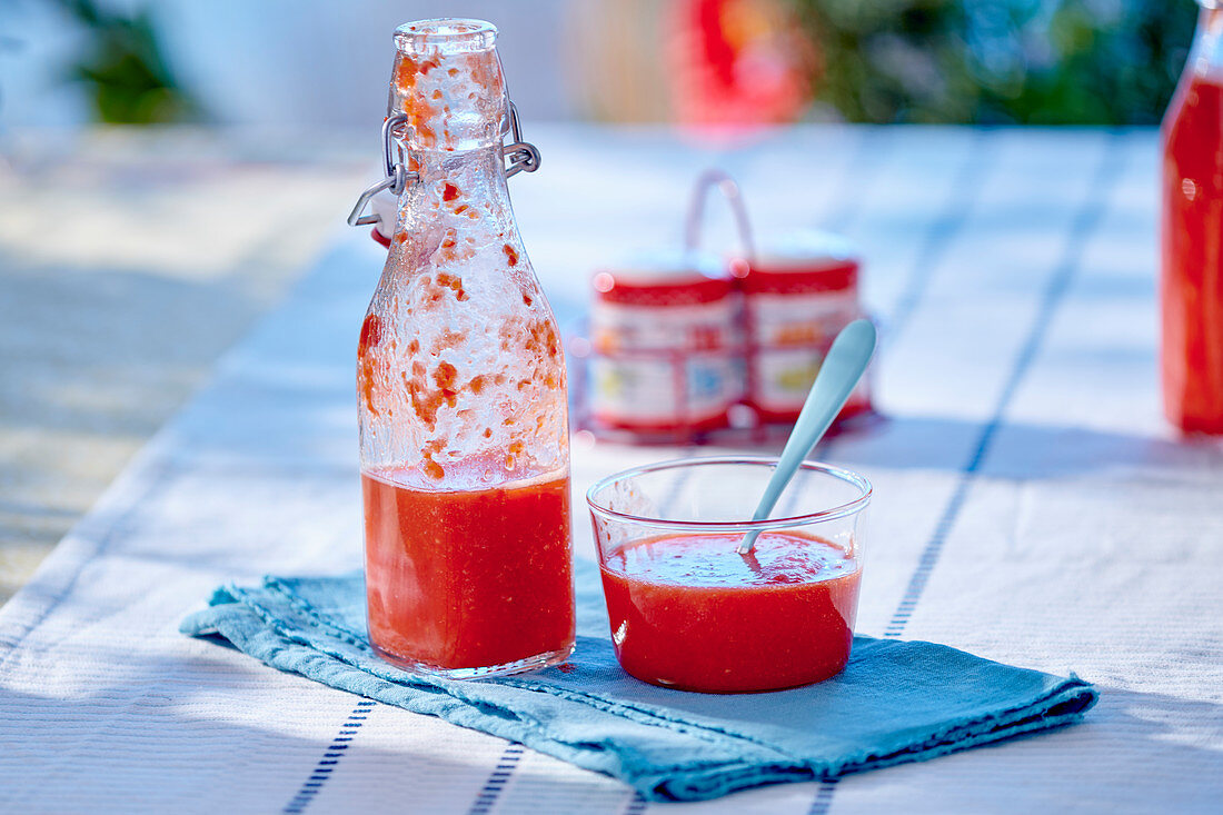 Tomato gazpacho in a bottle and a glass