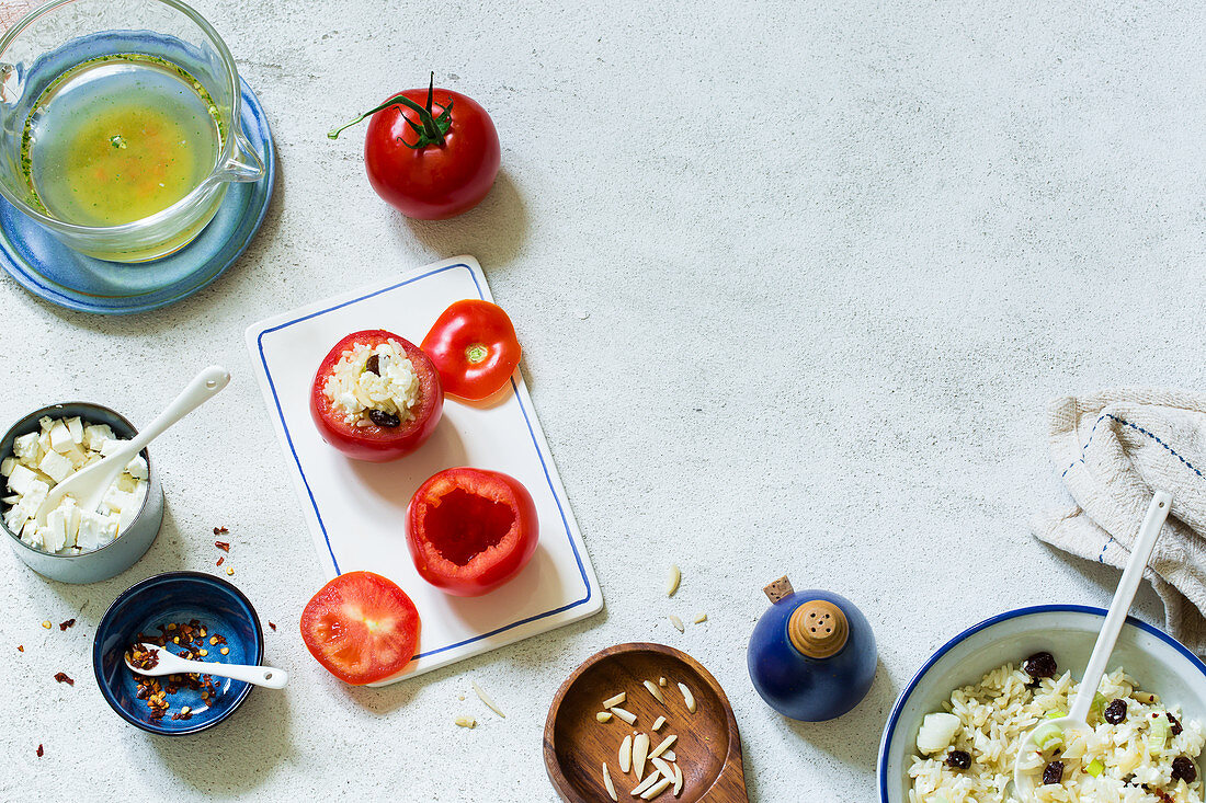 An arrangement of stuffed tomatoes and ingredients