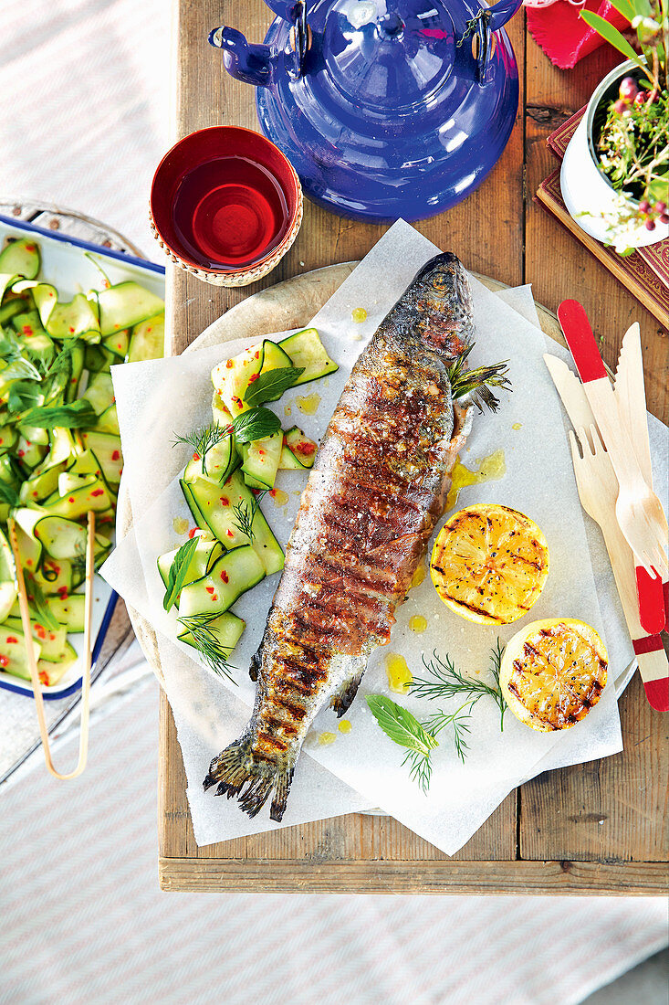 Prosciutto-wrapped trout with cured zucchini salad