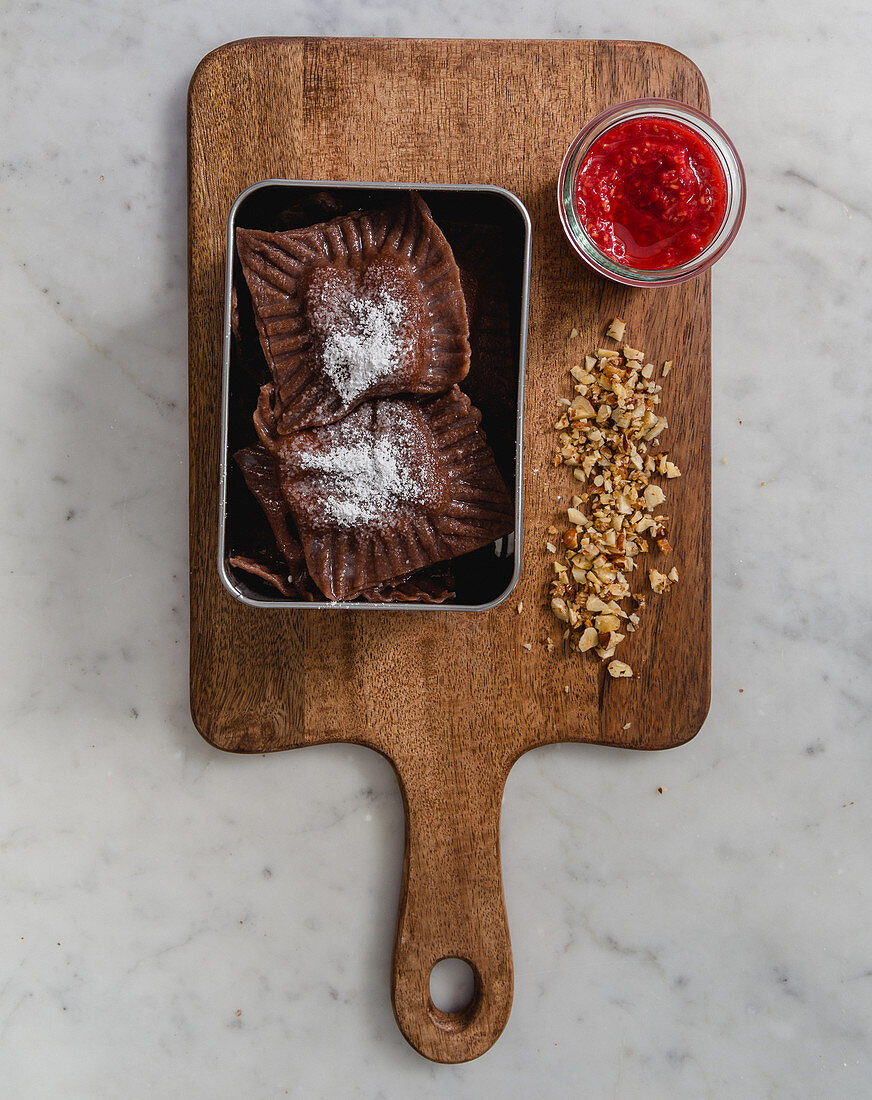 Sweet cocoa ravioli with a raspberry dip