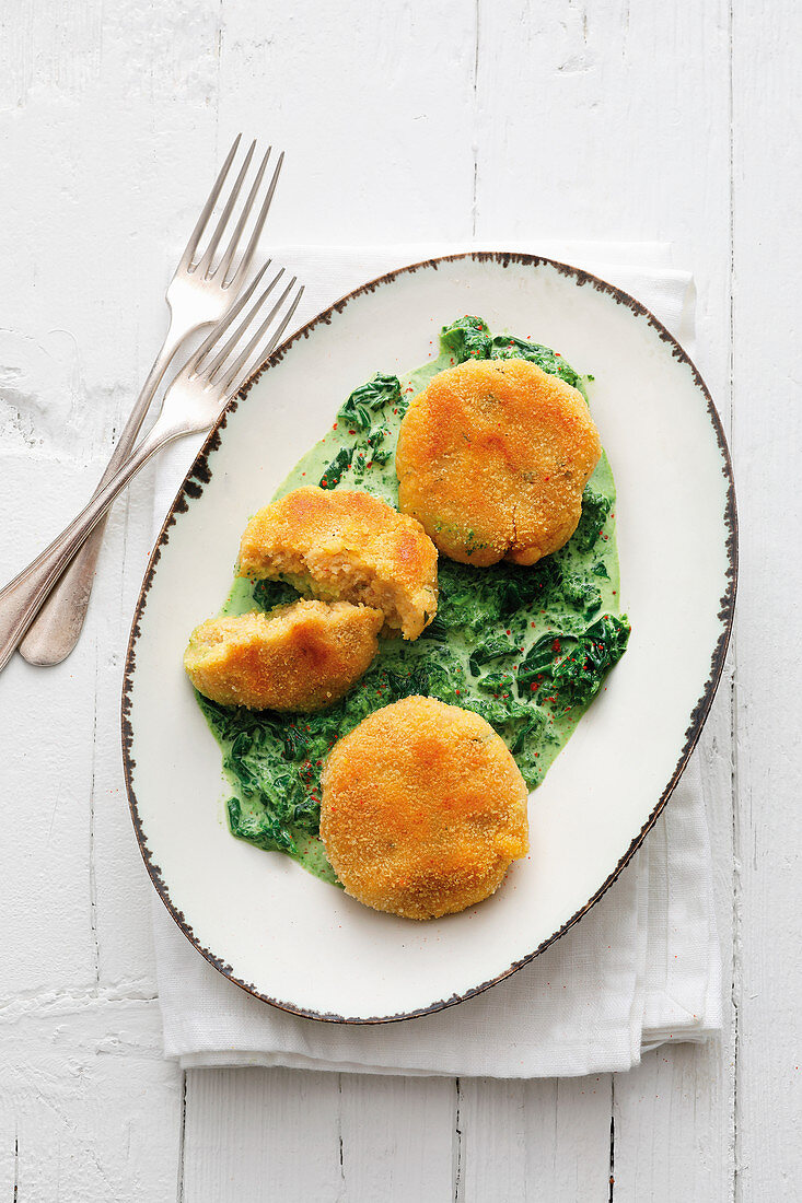 Polenta cakes on creamed spinach