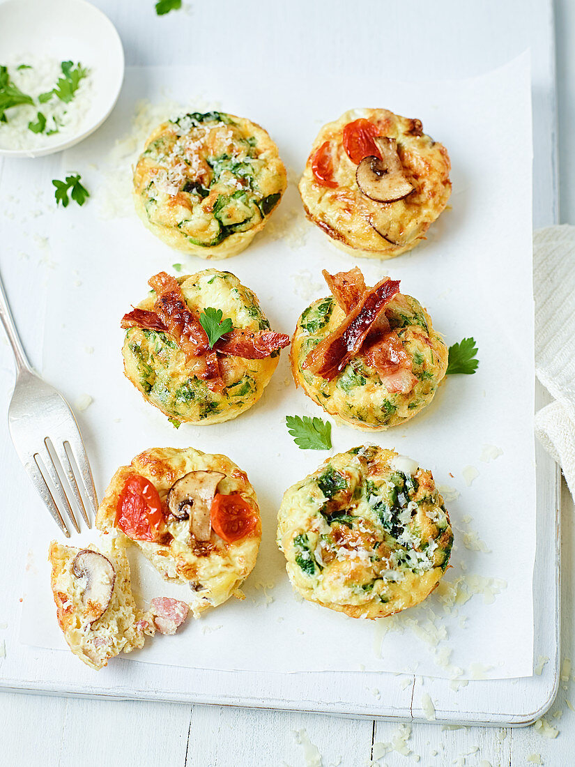 Frittata muffins with bacon, tomatoes, mushrooms and zucchini