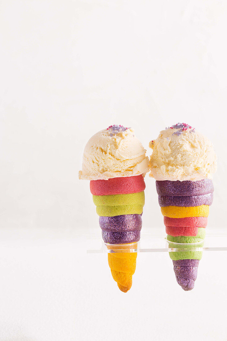 Rainbow waffle cones with vanilla ice cream