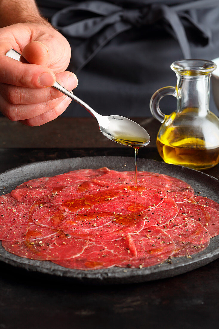 Beef carpaccio drizzled with olive oil