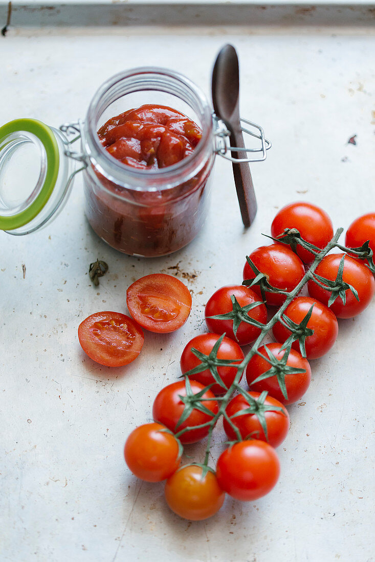 Tomato sauce in a glass and fresh cherry tomatoes