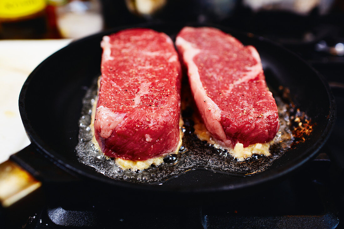 Beef loin being fried in a pan