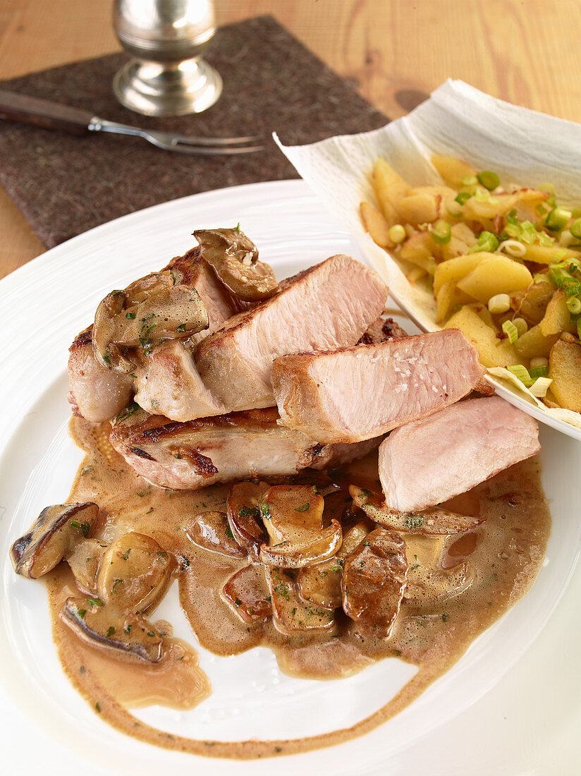 Pork chop chasseur with roast potatoes License Images 12470758