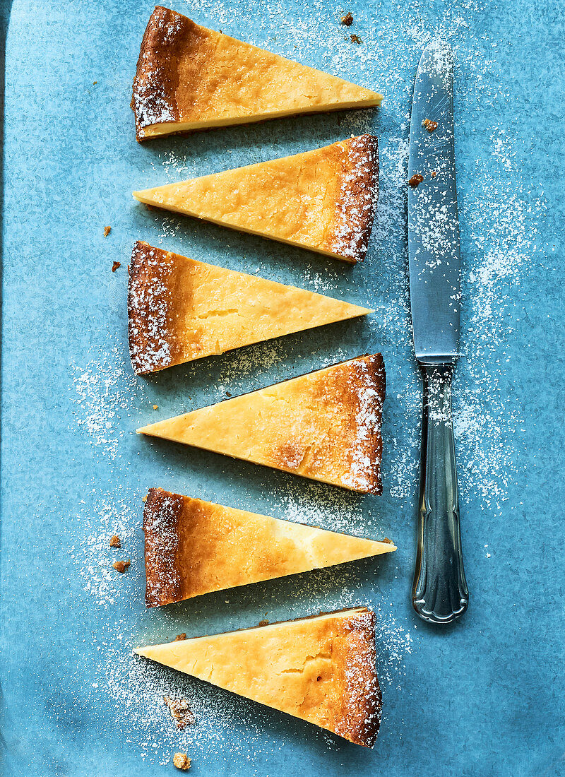 Slices of cheesecake on a blue wooden surface