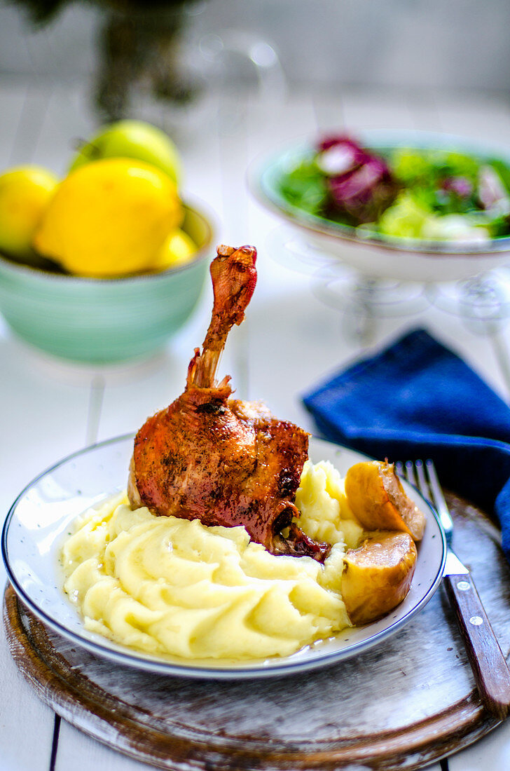 Duck leg with mashed potatoes and apple