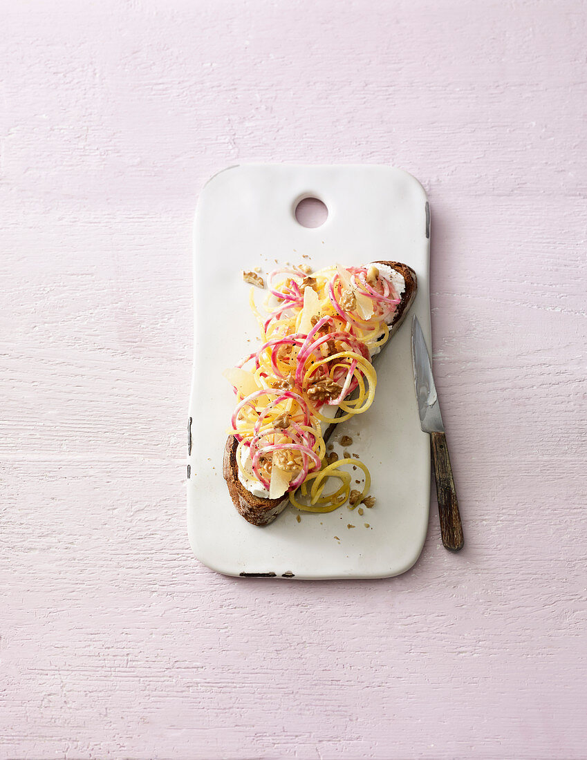 Chioggia beet on a slice of bread with grapefruit and nuts