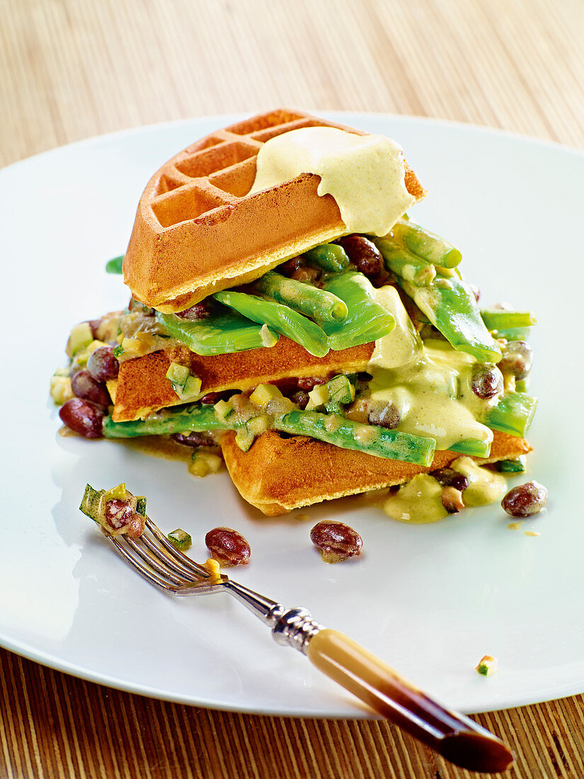 Potato waffles with bean melange and curry cream