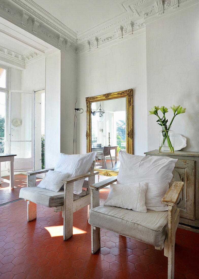 Two armchairs made from reclaimed wood in Mediterranean period apartment