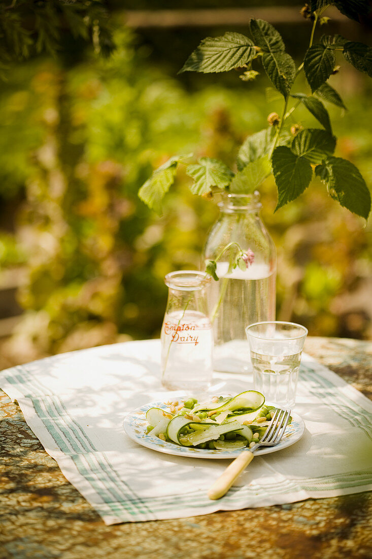 Zucchini and pea salad on a garden table