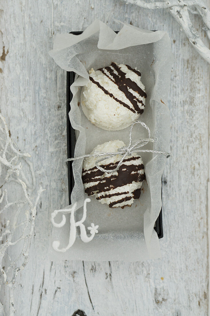 Coconut macaroons with chocolate glaze in a box