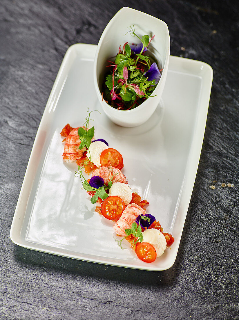 Herb salad with crayfish and white tomato mousse