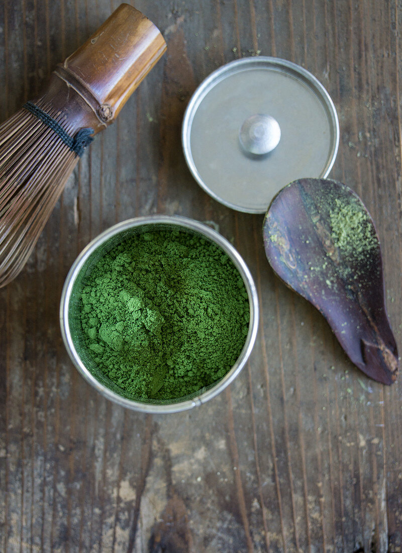 Matcha in a tea caddy, a matcha spoon and a tea whisk