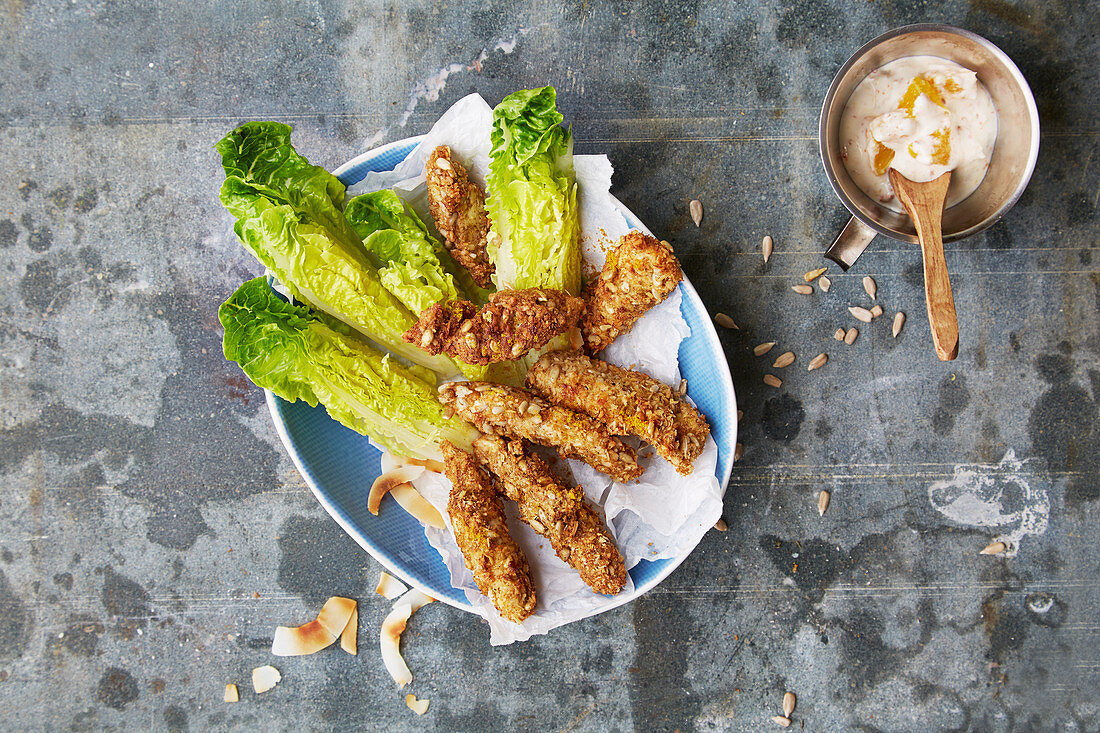 Chicken sticks with a coconut and curry coating