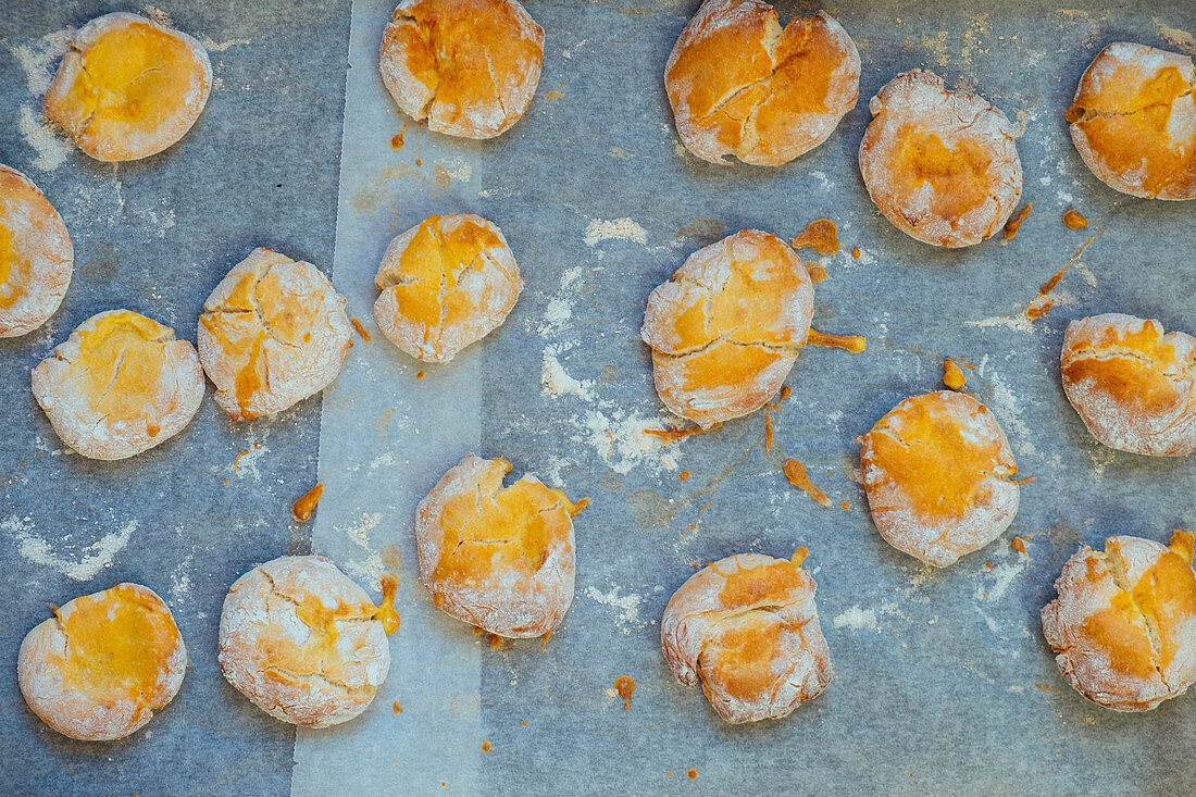 Freshly baked scones on baking paper (top view)