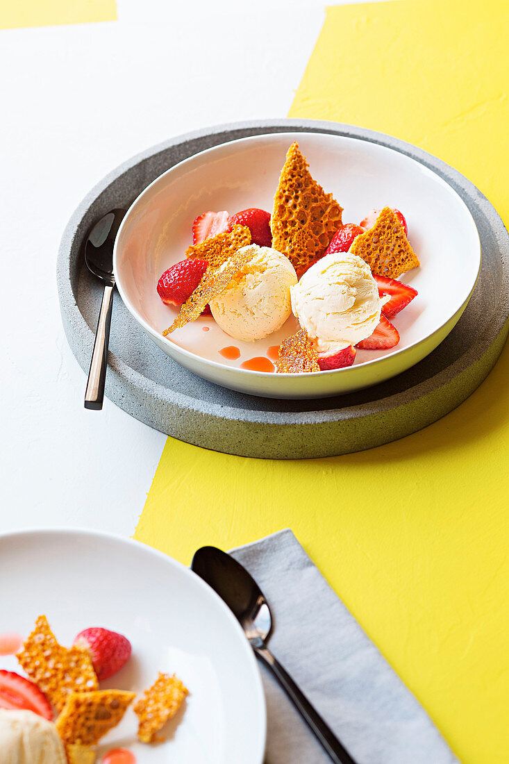 Cream cheese ice cream with strawberries and honeycomb