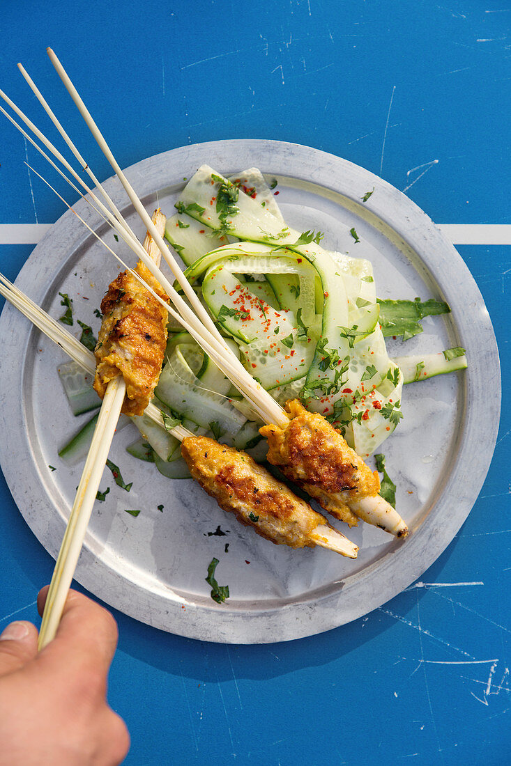 Prawn and chicken satay with cucumber salad