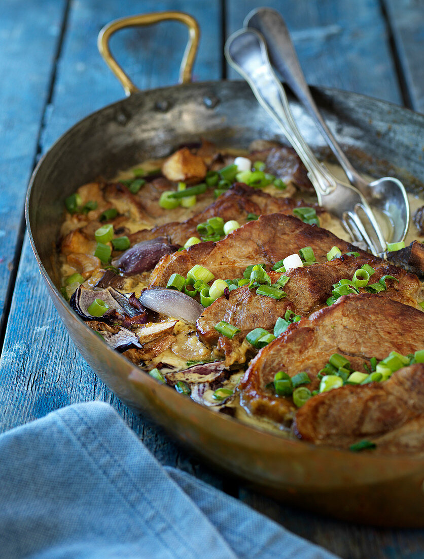 Pork chops with spring onions and mushrooms
