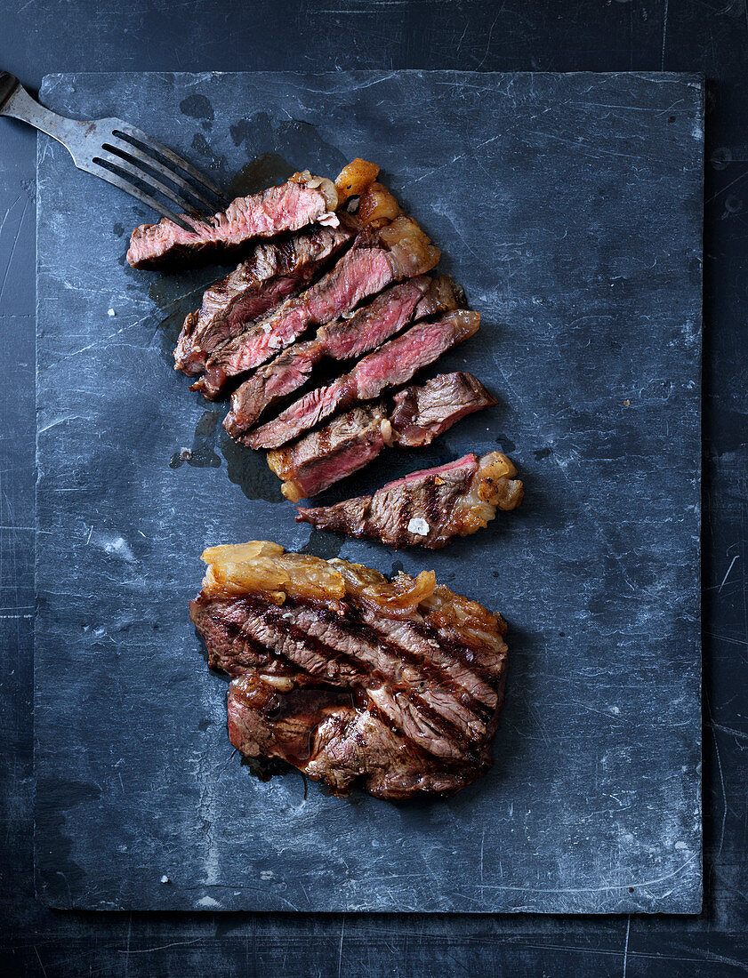 Grilled flat iron steak, partly sliced