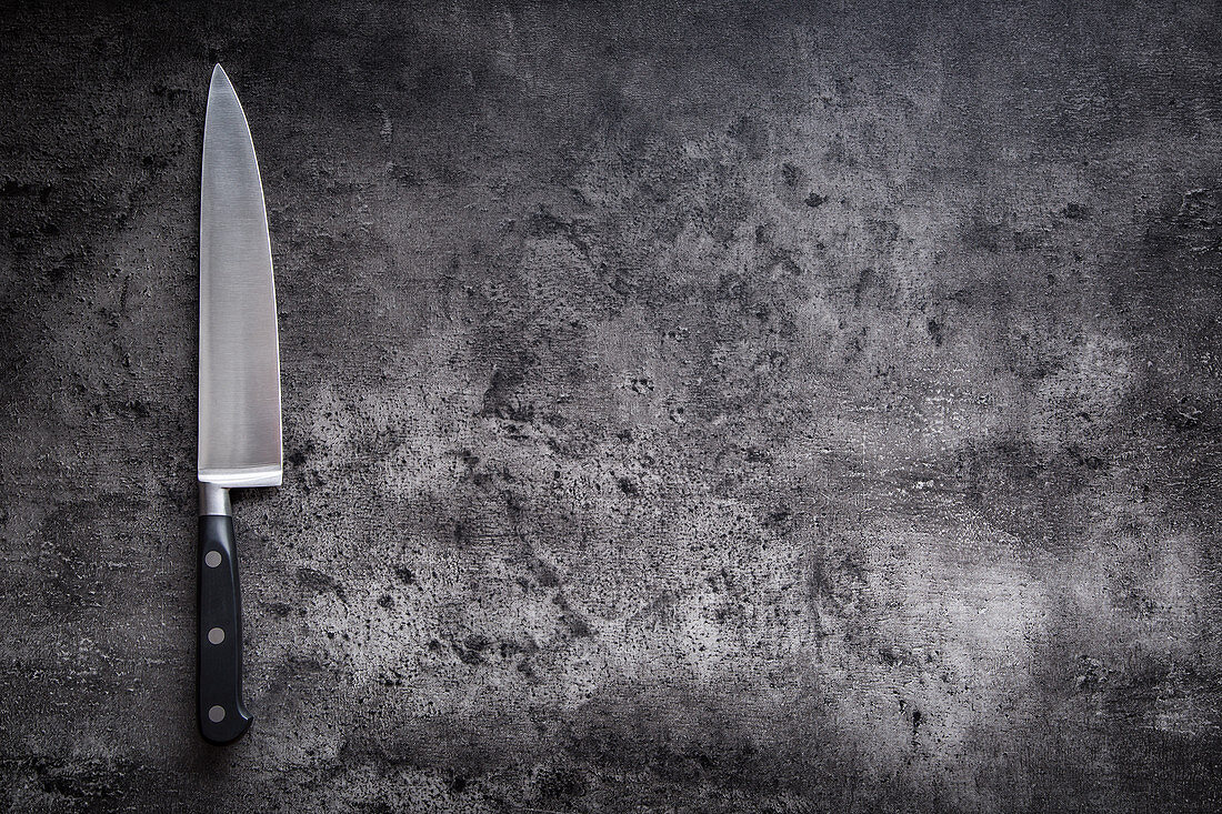 A kitchen knife on a grey background