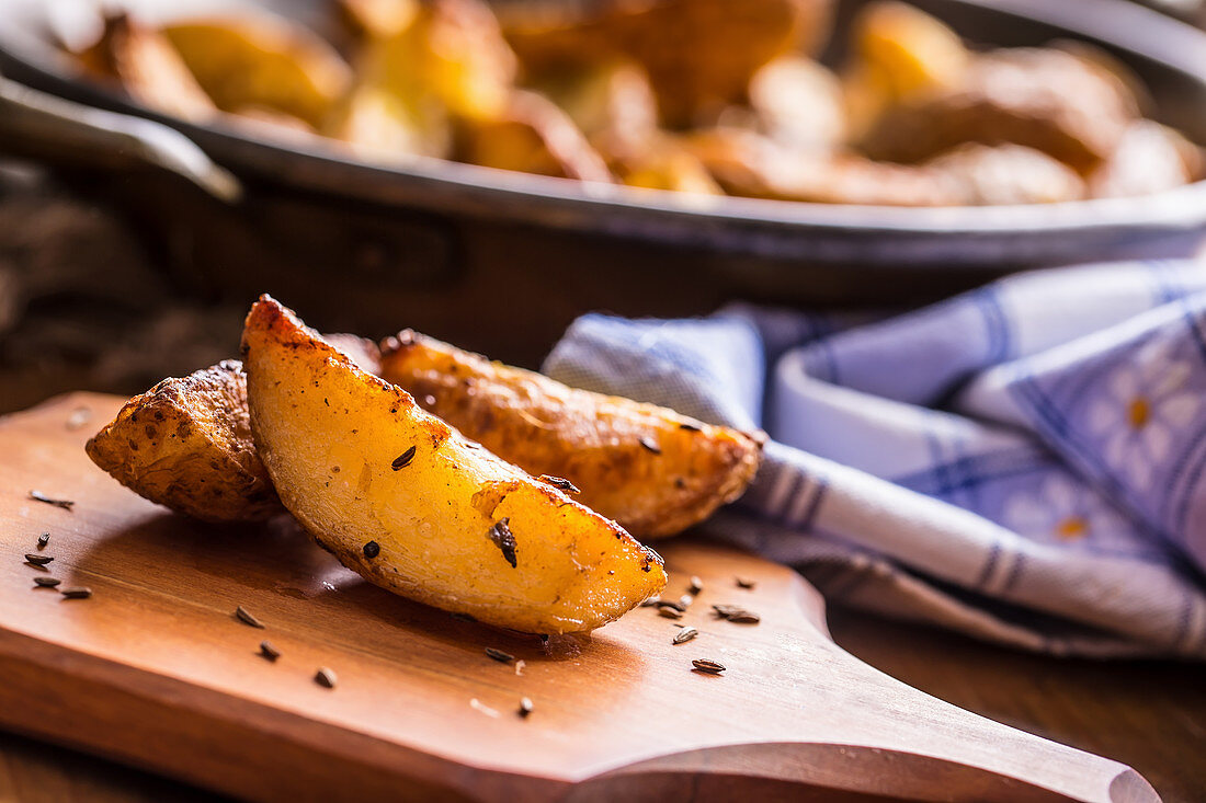 Roasted potato wedges with caraway seeds (close up)