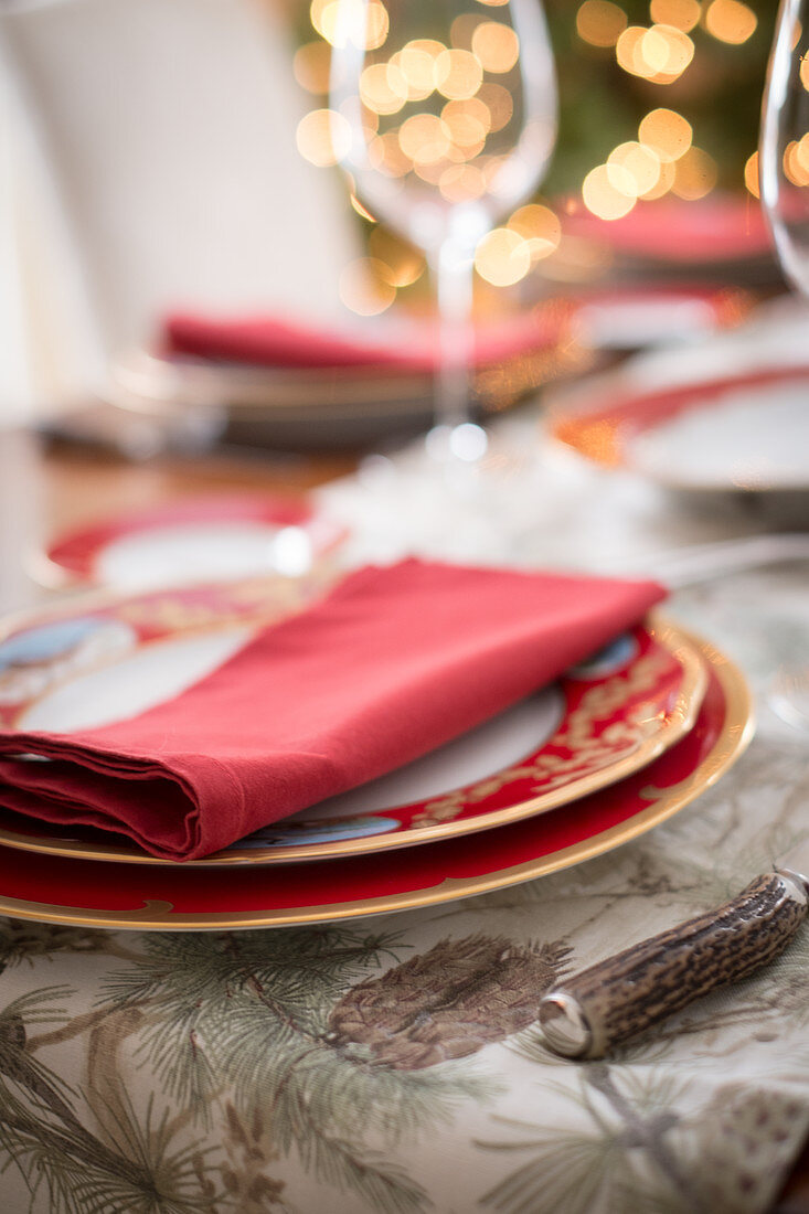 A Christmas place setting with a red napkin